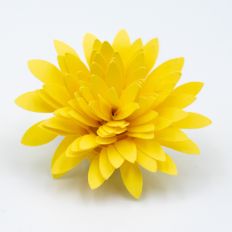 bright yellow rolled paper flower with narrow pointed petals