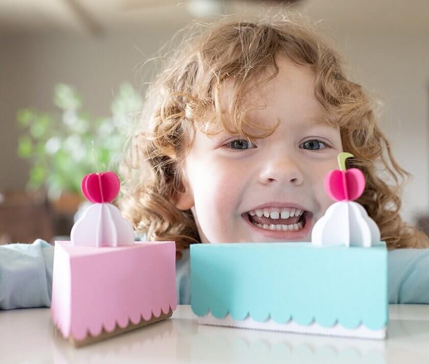 Image of baby girl in front of two cake